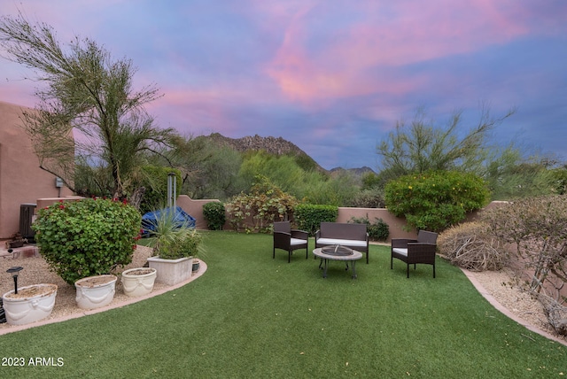 yard at dusk with a fire pit