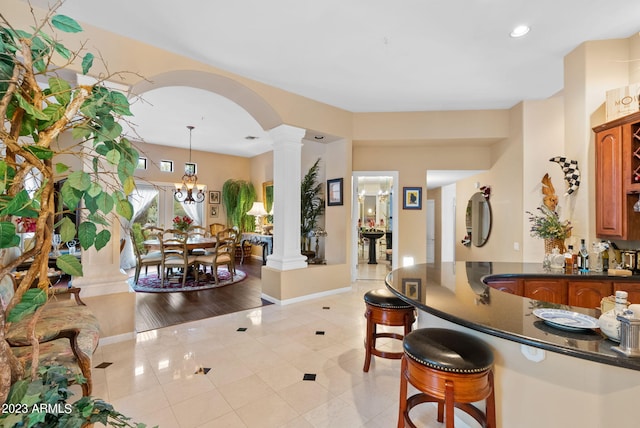 foyer with decorative columns and light hardwood / wood-style floors