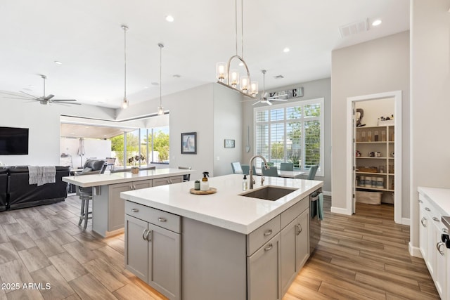 2630 E Lovebird Ln, Gilbert, AZ 85297 - kitchen featuring an island with sink, open floor plan, ceiling fan, dishwasher, and light countertops