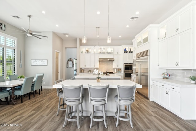 2630 E Lovebird Ln, Gilbert, AZ 85297 - kitchen featuring stainless steel appliances, a kitchen island with sink, backsplash, light countertops, and recessed lighting