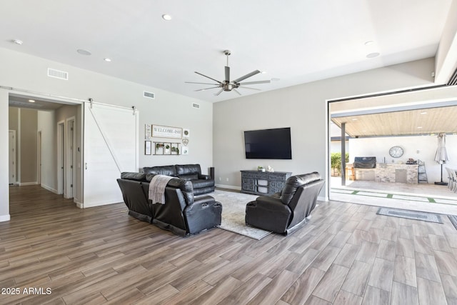 2630 E Lovebird Ln, Gilbert, AZ 85297 - living area featuring a barn door, wood finished floors, ceiling fan, and recessed lighting