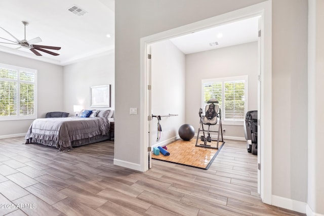 2630 E Lovebird Ln, Gilbert, AZ 85297 - bedroom with multiple windows, light wood-style floors, recessed lighting, and ceiling fan