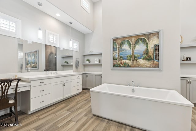 2630 E Lovebird Ln, Gilbert, AZ 85297 - full bathroom with vanity, a high ceiling, a freestanding tub, wood finished floors, and recessed lighting