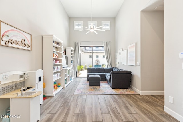 2630 E Lovebird Ln, Gilbert, AZ 85297 - living room with wood finished floors, a ceiling fan, and a towering ceiling