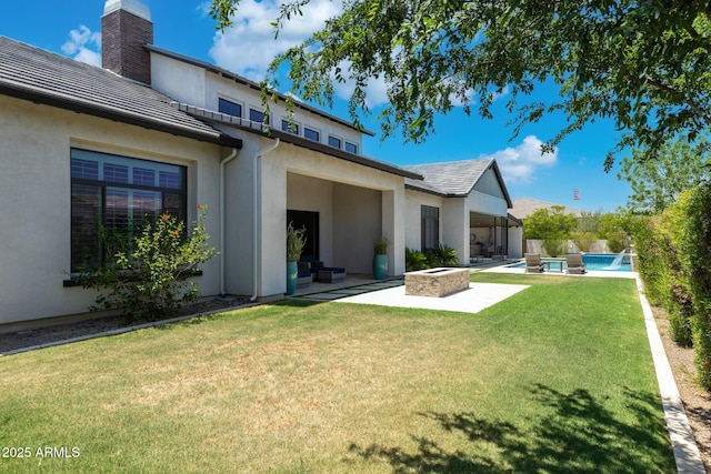 2630 E Lovebird Ln, Gilbert, AZ 85297 - back of property with an outdoor fire pit, a yard, a patio area, stucco siding, and a chimney
