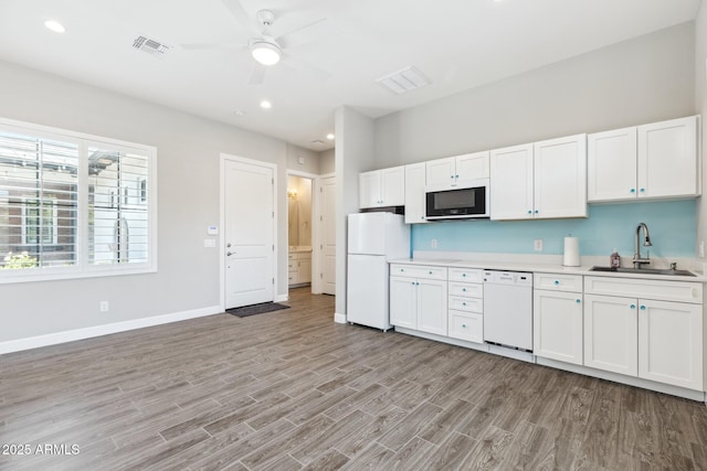 2630 E Lovebird Ln, Gilbert, AZ 85297 - kitchen with white appliances, light wood-style floors, ceiling fan, light countertops, and white cabinets