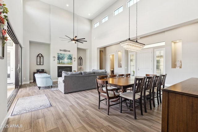 2630 E Lovebird Ln, Gilbert, AZ 85297 - dining area featuring light wood-style floors, a ceiling fan, a high ceiling, and recessed lighting