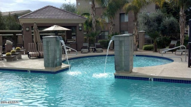 pool featuring fence and a patio area