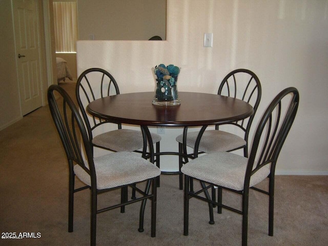 dining space with baseboards and carpet floors