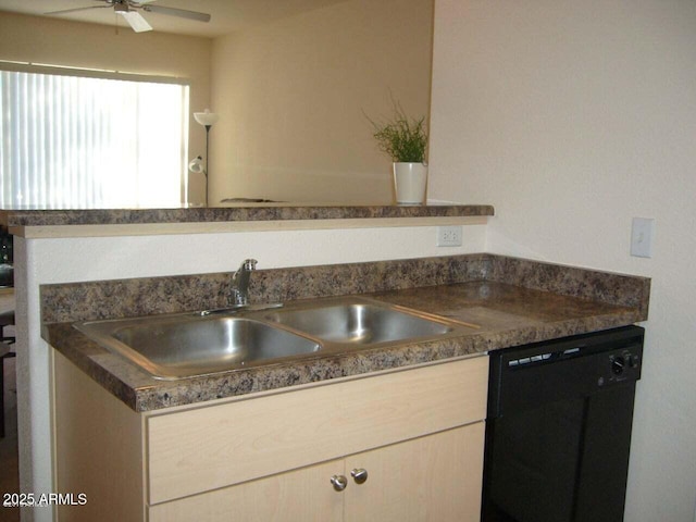 kitchen with a sink, black dishwasher, dark countertops, and a ceiling fan