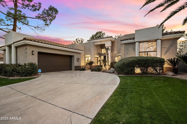 view of front facade featuring a garage and a lawn