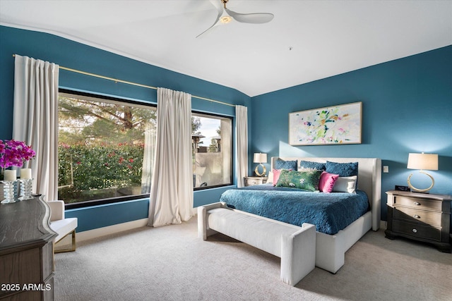 bedroom with ceiling fan, lofted ceiling, and carpet flooring