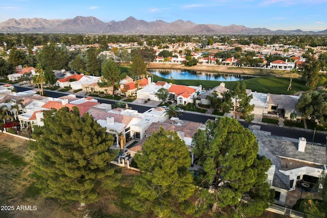 drone / aerial view featuring a water and mountain view