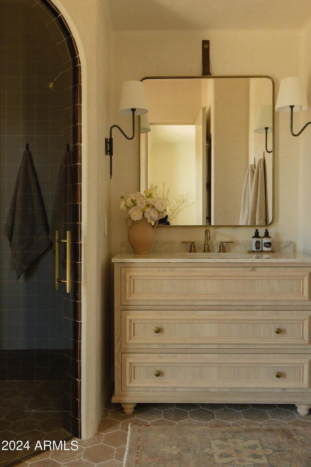 bathroom with an enclosed shower, oversized vanity, and tile flooring