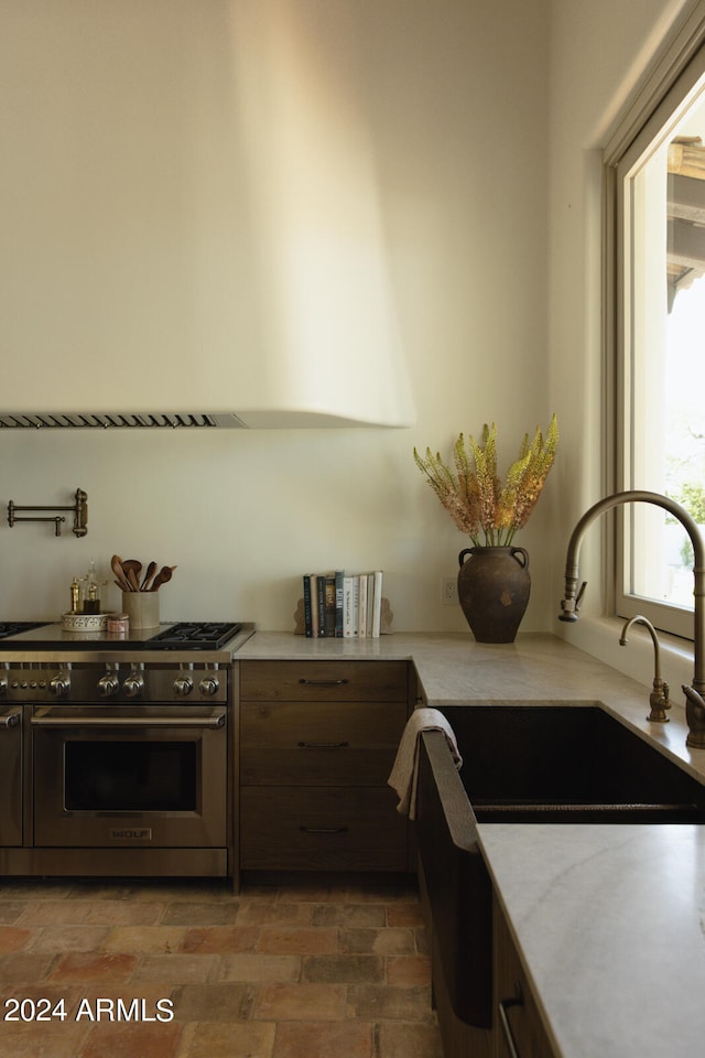 kitchen featuring luxury stove and sink