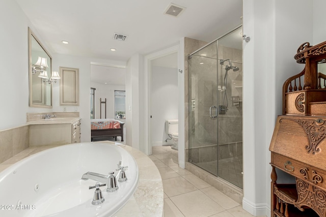 bathroom featuring visible vents, toilet, a stall shower, and a whirlpool tub