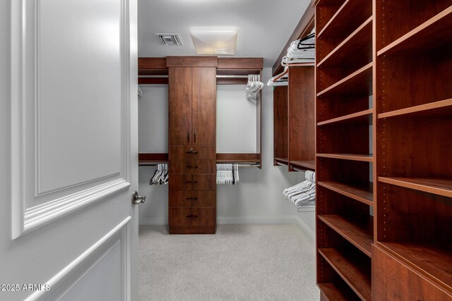 spacious closet featuring visible vents and carpet flooring