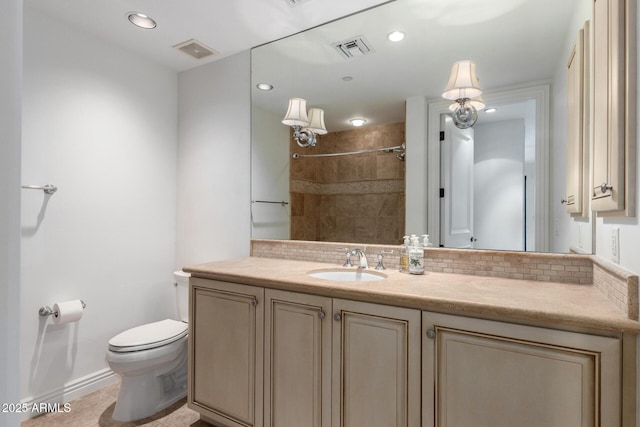 bathroom featuring backsplash, visible vents, toilet, and vanity