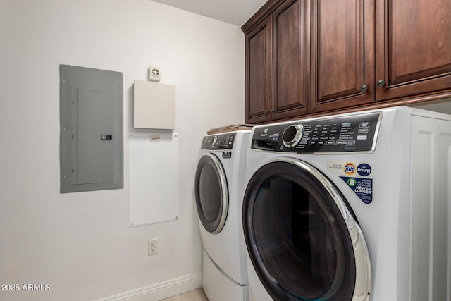 laundry room with separate washer and dryer, electric panel, cabinet space, and baseboards