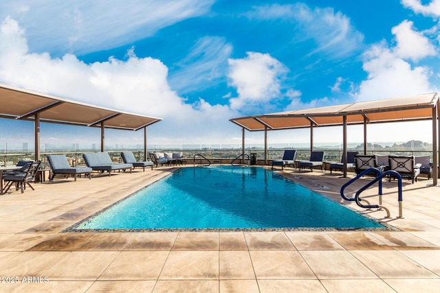 community pool featuring a patio and fence