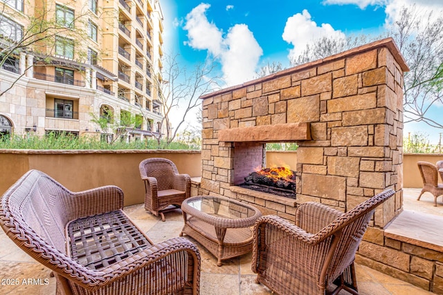 view of patio with an outdoor stone fireplace