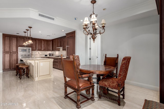 dining space featuring visible vents, baseboards, ornamental molding, recessed lighting, and a notable chandelier