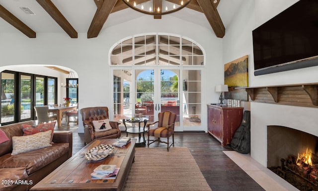 living room featuring wood-type flooring, beam ceiling, french doors, and a healthy amount of sunlight