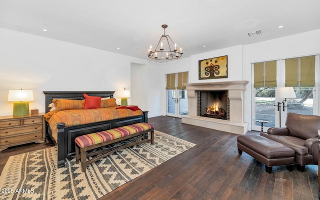 bedroom featuring dark wood-type flooring and an inviting chandelier