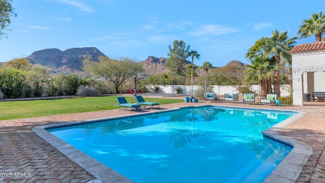 view of pool featuring a mountain view and a yard