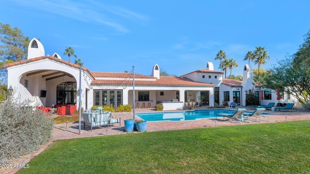 back of house featuring a patio area and a yard