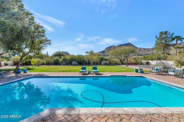 view of swimming pool with a mountain view, a yard, and a patio