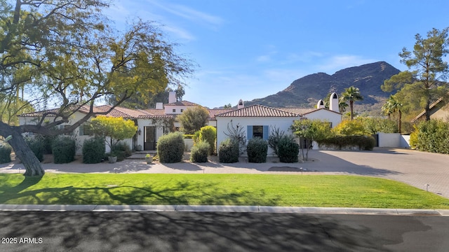 mediterranean / spanish home featuring a mountain view and a front yard