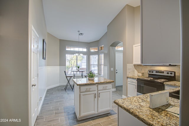 kitchen featuring light stone counters, pendant lighting, a center island, range with electric cooktop, and white cabinets