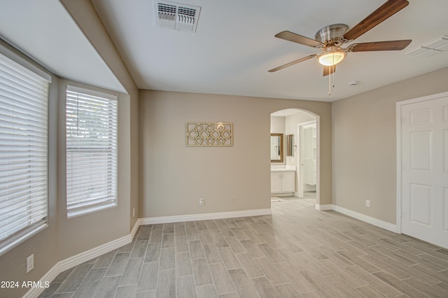 spare room with ceiling fan and light wood-type flooring