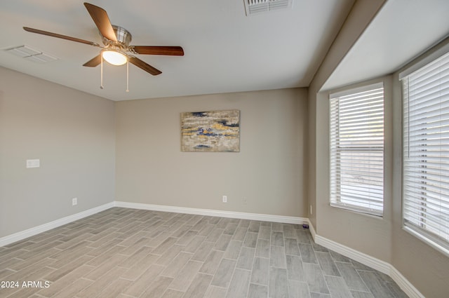 unfurnished room with ceiling fan and light wood-type flooring