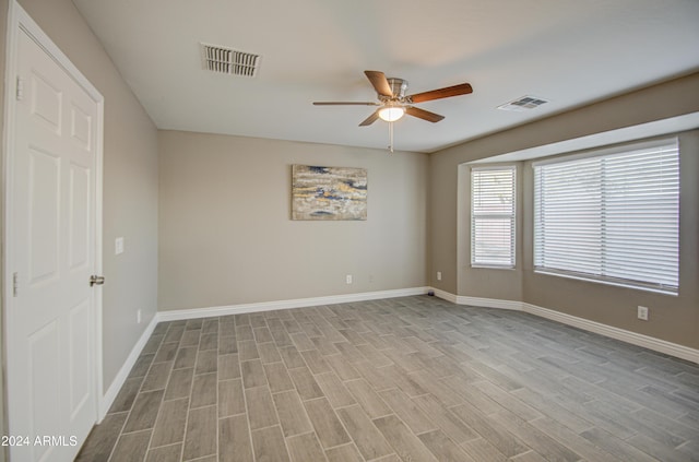 empty room featuring light wood-type flooring and ceiling fan