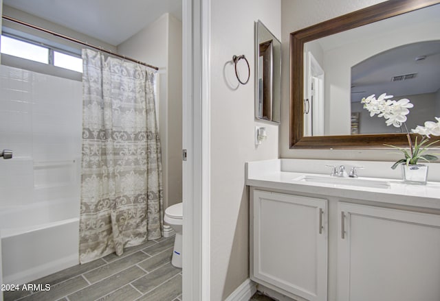 full bathroom with toilet, vanity, and shower / bath combo with shower curtain