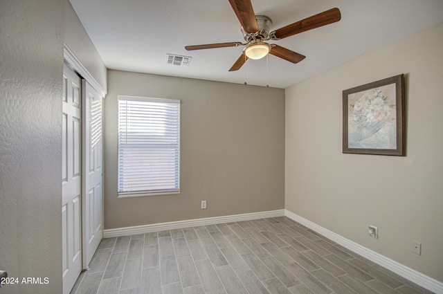 spare room with ceiling fan and light wood-type flooring