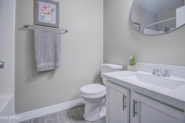 bathroom with a shower, vanity, and toilet