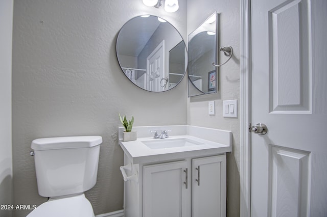 bathroom with toilet and vanity