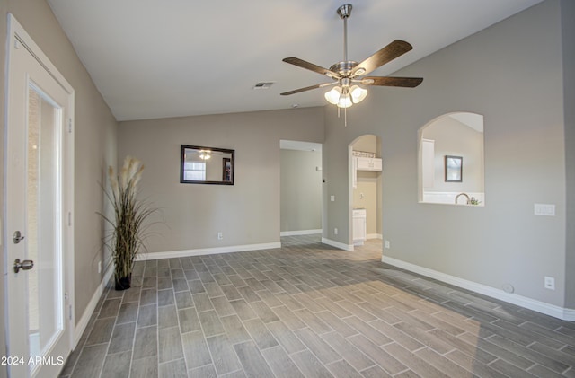 spare room featuring ceiling fan, light hardwood / wood-style flooring, and lofted ceiling