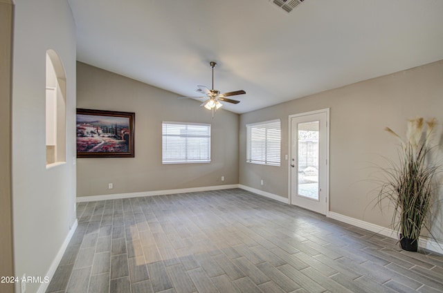 empty room featuring ceiling fan and vaulted ceiling