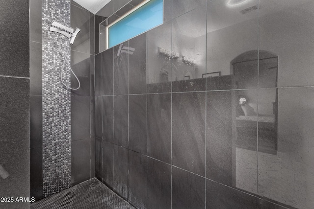 bathroom with tiled shower