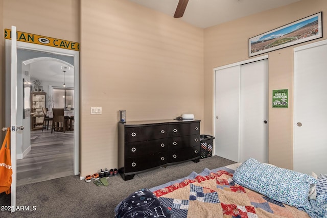 bedroom with ceiling fan, a closet, and light colored carpet