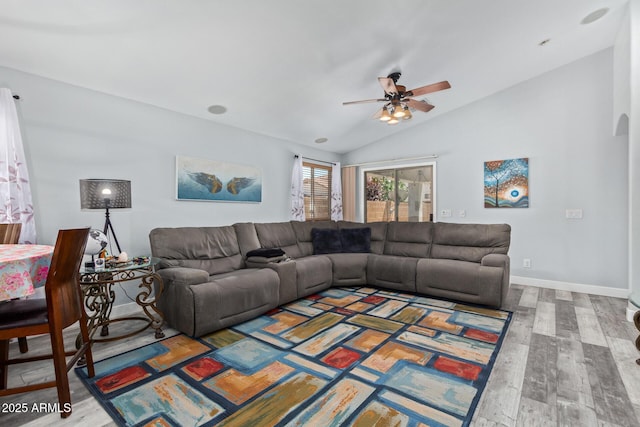 living room with ceiling fan, wood-type flooring, and vaulted ceiling