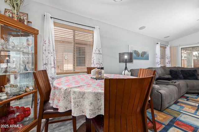 dining room featuring lofted ceiling