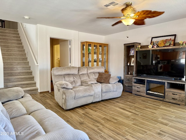 1758 E San Xavier Dr, Casa Grande, AZ 85122 - living area featuring stairway, ceiling fan, and light wood-style floors