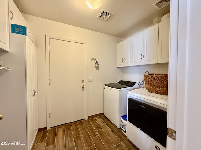 1758 E San Xavier Dr, Casa Grande, AZ 85122 - laundry room featuring cabinet space, washing machine and dryer, wood tiled floors, and baseboards