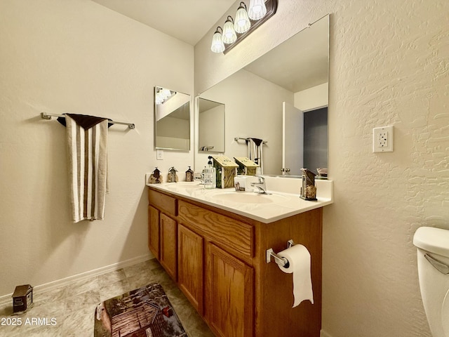 1758 E San Xavier Dr, Casa Grande, AZ 85122 - bathroom featuring double vanity, toilet, and baseboards