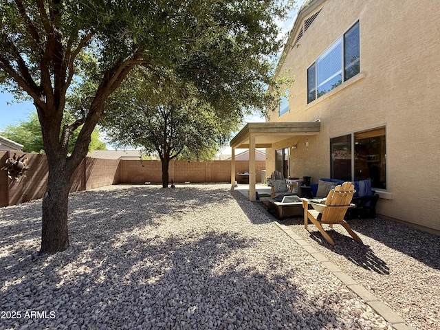 1758 E San Xavier Dr, Casa Grande, AZ 85122 - fenced backyard with an outdoor fire pit and a patio area